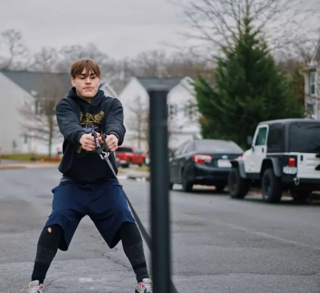 Athlete pulling weighted sled during workout