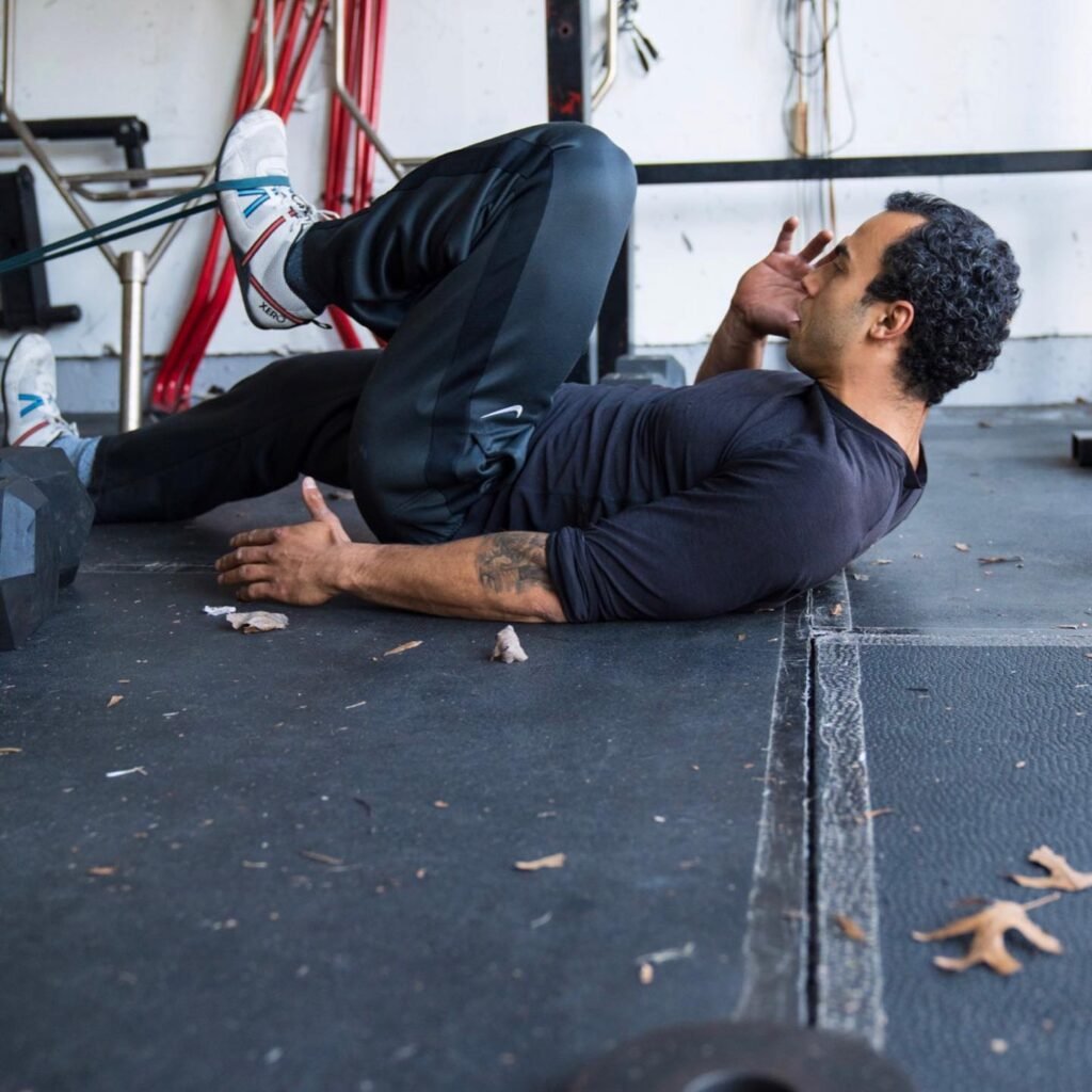 Person doing adult personal training session banded hip stretches