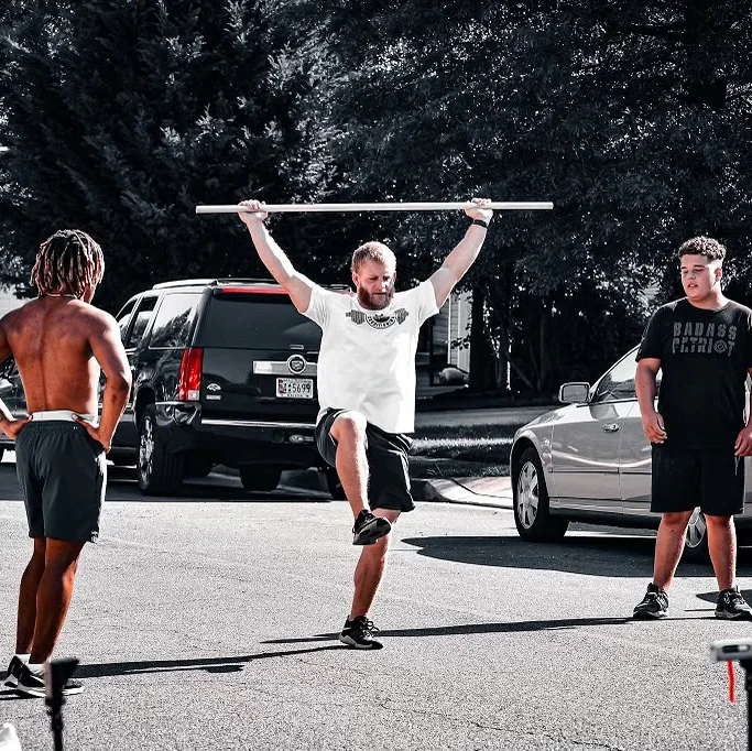 Peak Performance coach demonstrating leg drill to athletes
